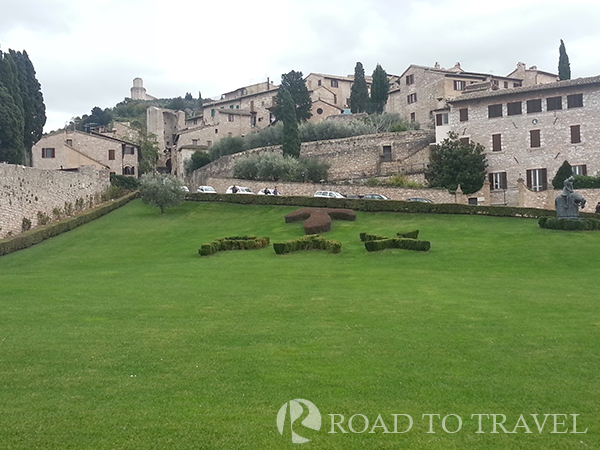 St Francis Basilicas Garden The cros of tau in the garden outside the Upper Basilica of St Francis. Continuing walking to via San Francesco you enter in the medioval town of Asissi.