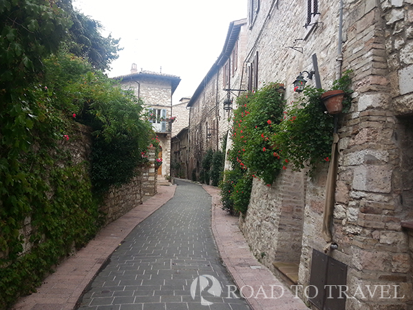 Assisi Entrance from Piazza Matteotti Entrance in the nedieval town cisty centre of Assisi from Piazza Matteotti parking